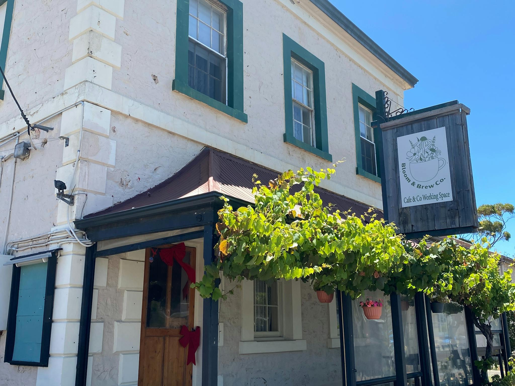 front of Bloom & Brew Co Building, showing front veranda
