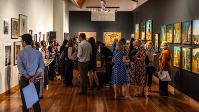 A group of people exploring the Nolan Collection at Canberra Museum + Gallery