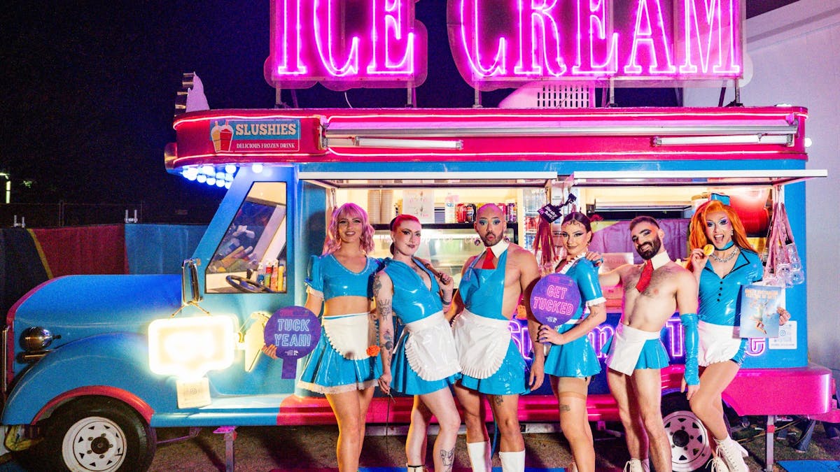 Performers in retro costumes posing in front of an ice cream truck.