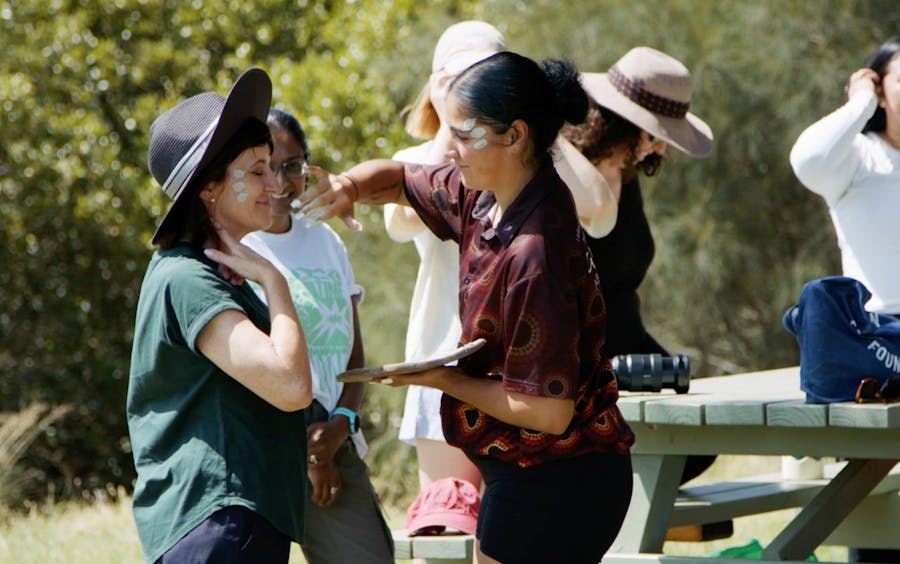 person applying ochre to someone else