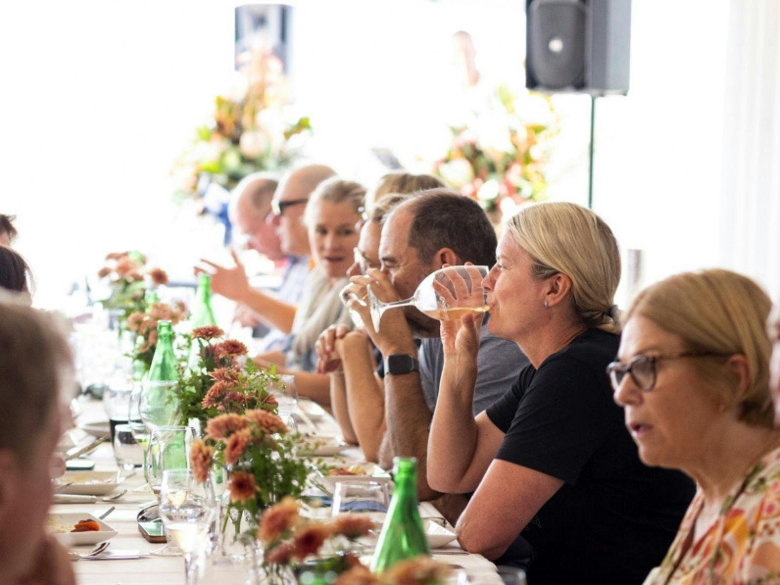 Gapsted Estate Long Lunch guests sitting at the long communal tables enjoying wine and a meal