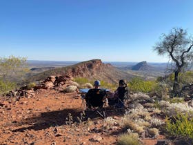 Couple enjoying the views and serenity after landing on top of the East MacDonnell Ranges