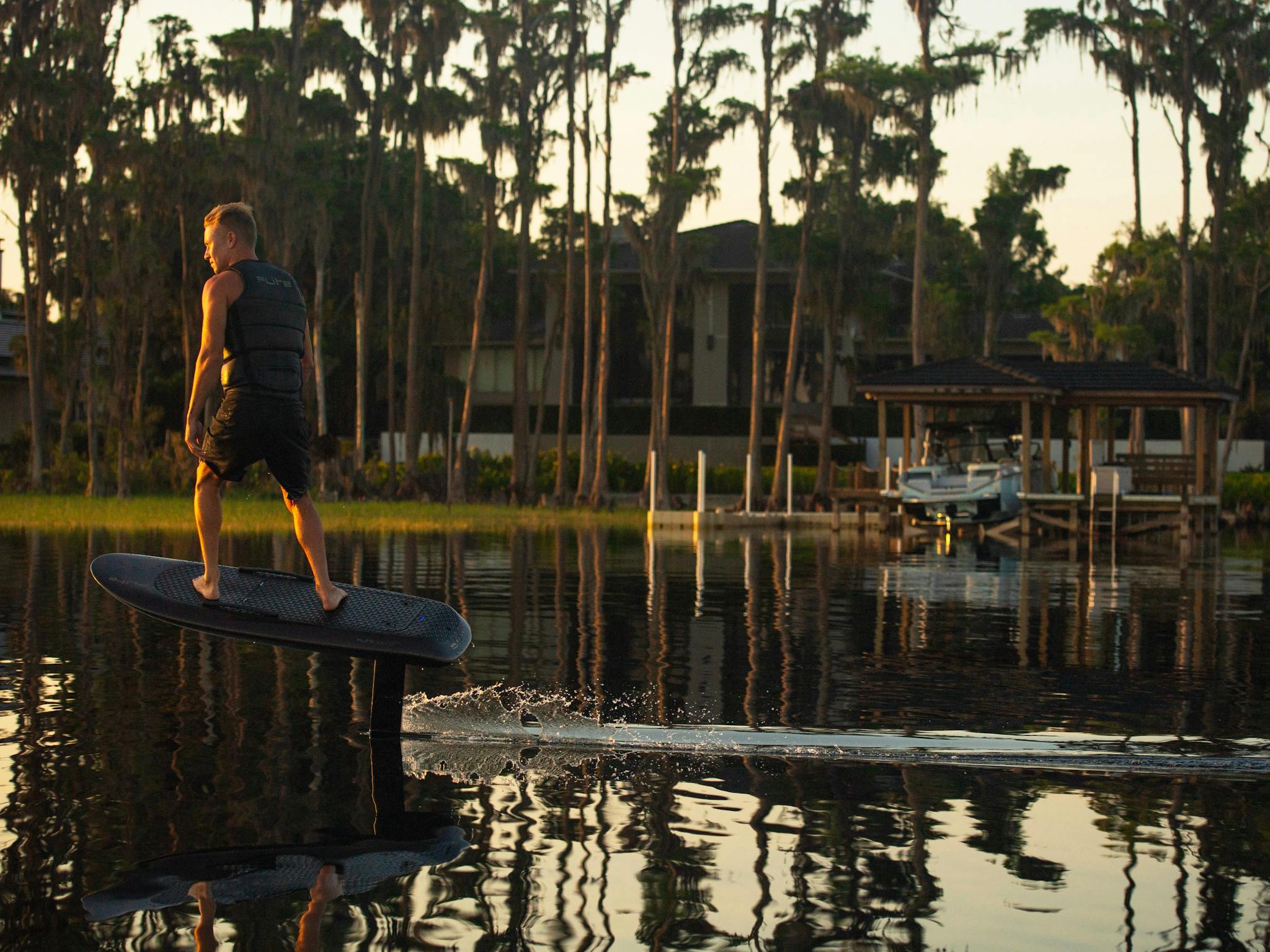 Man at sunset efoiling on Fliteboard Man at sunset efoiling on Fliteboard