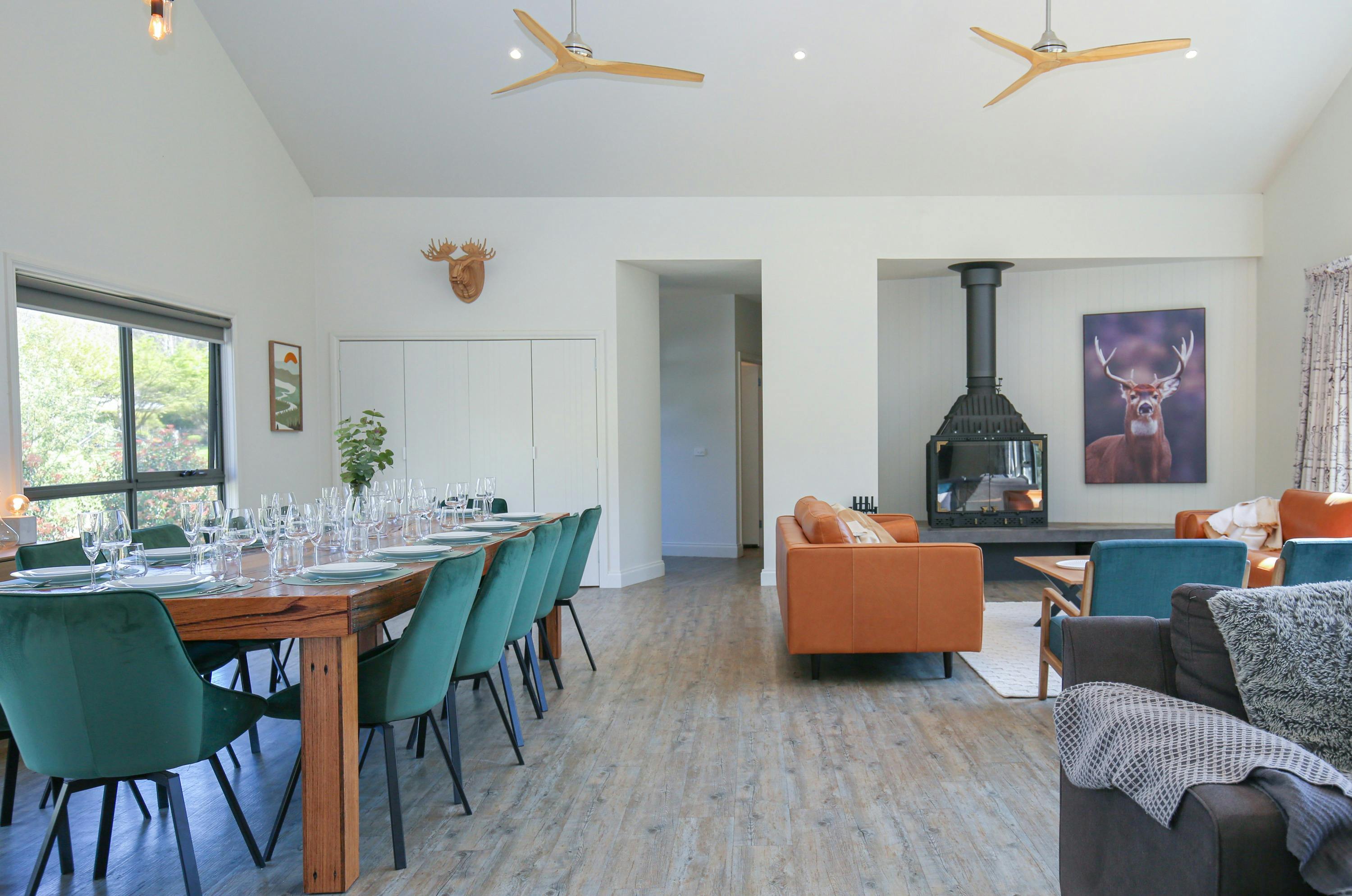 Northern Exposure Bright living and dining room featuring large dining table, couche and fireplace