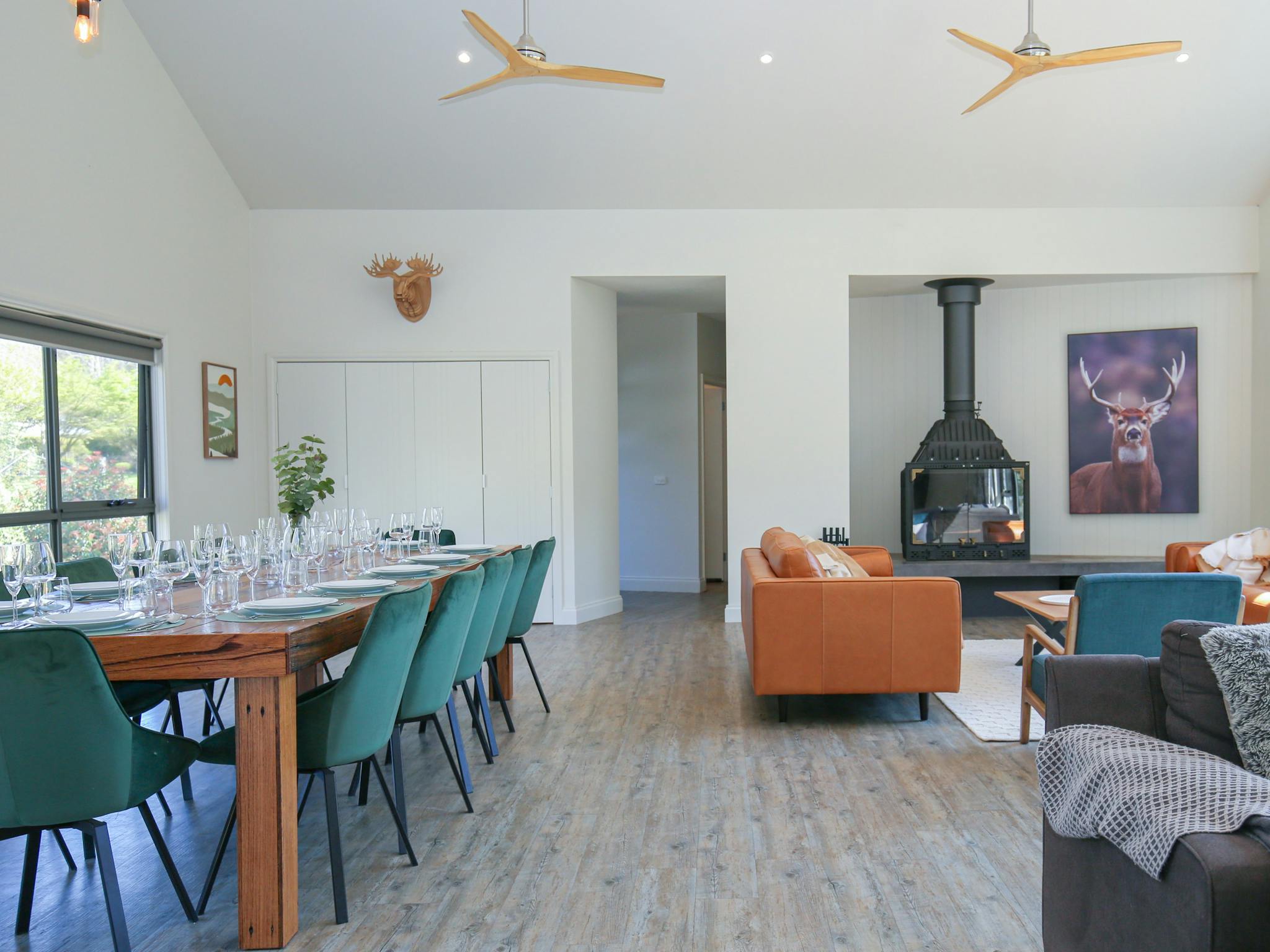 Northern Exposure Bright living and dining room featuring large dining table, couche and fireplace