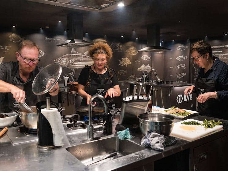 three people cooking