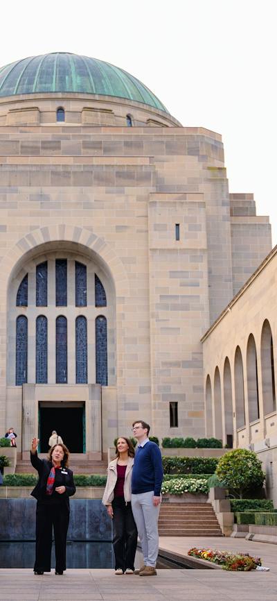 Group of visitors standing in the Commemorative Area in front of the Hall of Memory