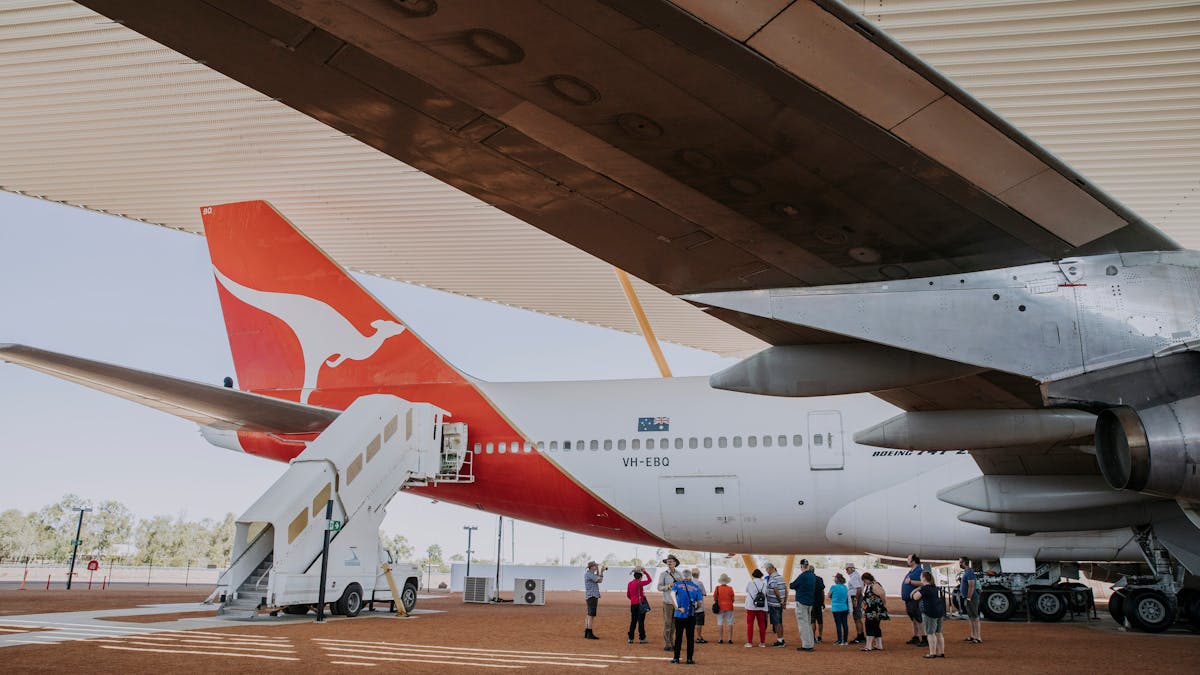 Image captured by Tourism & Events Queensland of an airpark tour taking place under the 747 wing.