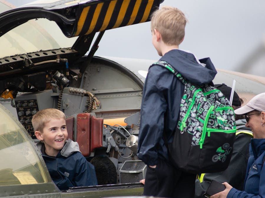 Children engaging and sitting in the planes