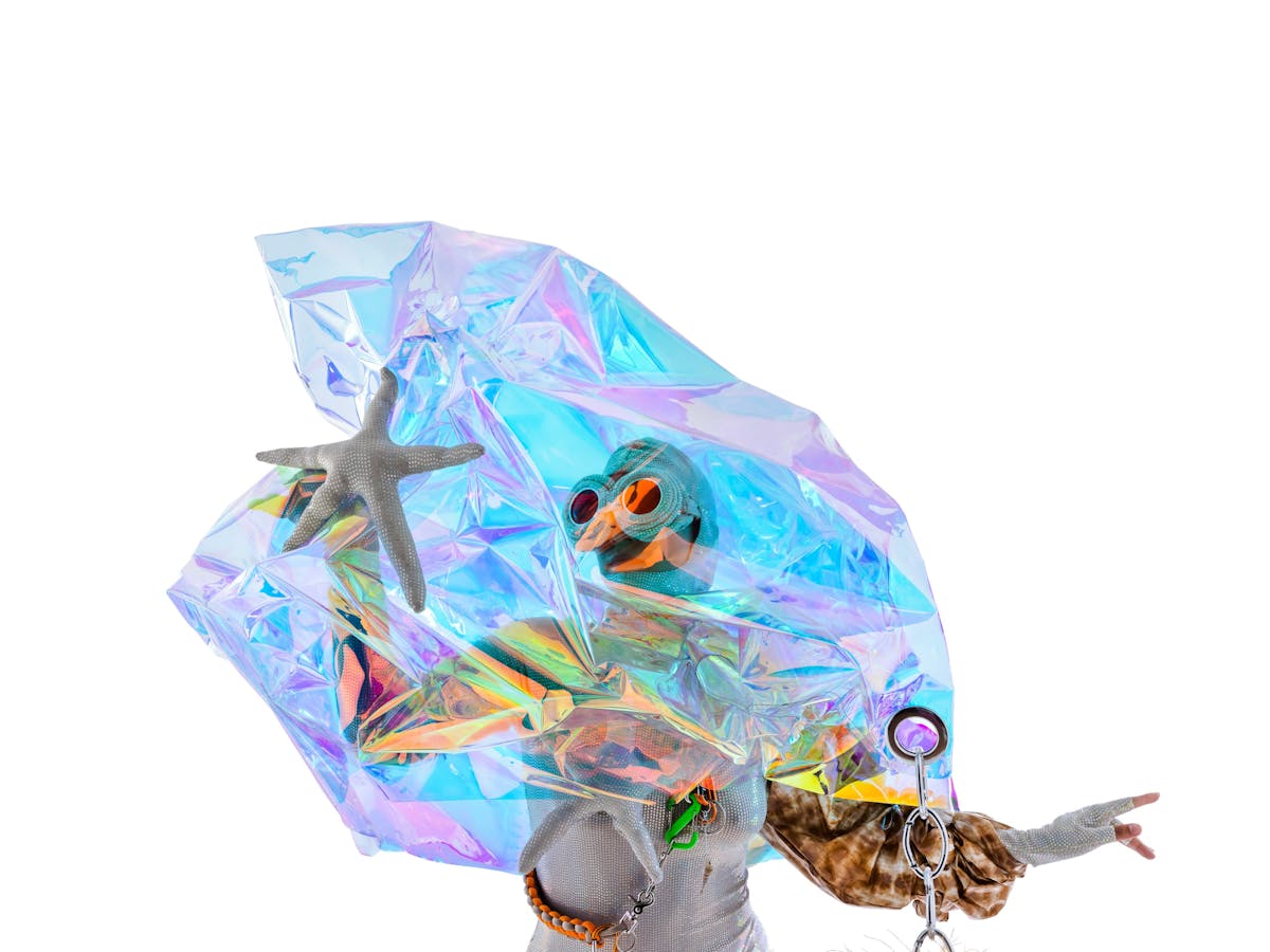 Performer wearing colourful, aquatic-themed costume with large goggles, and superimposed starfishes