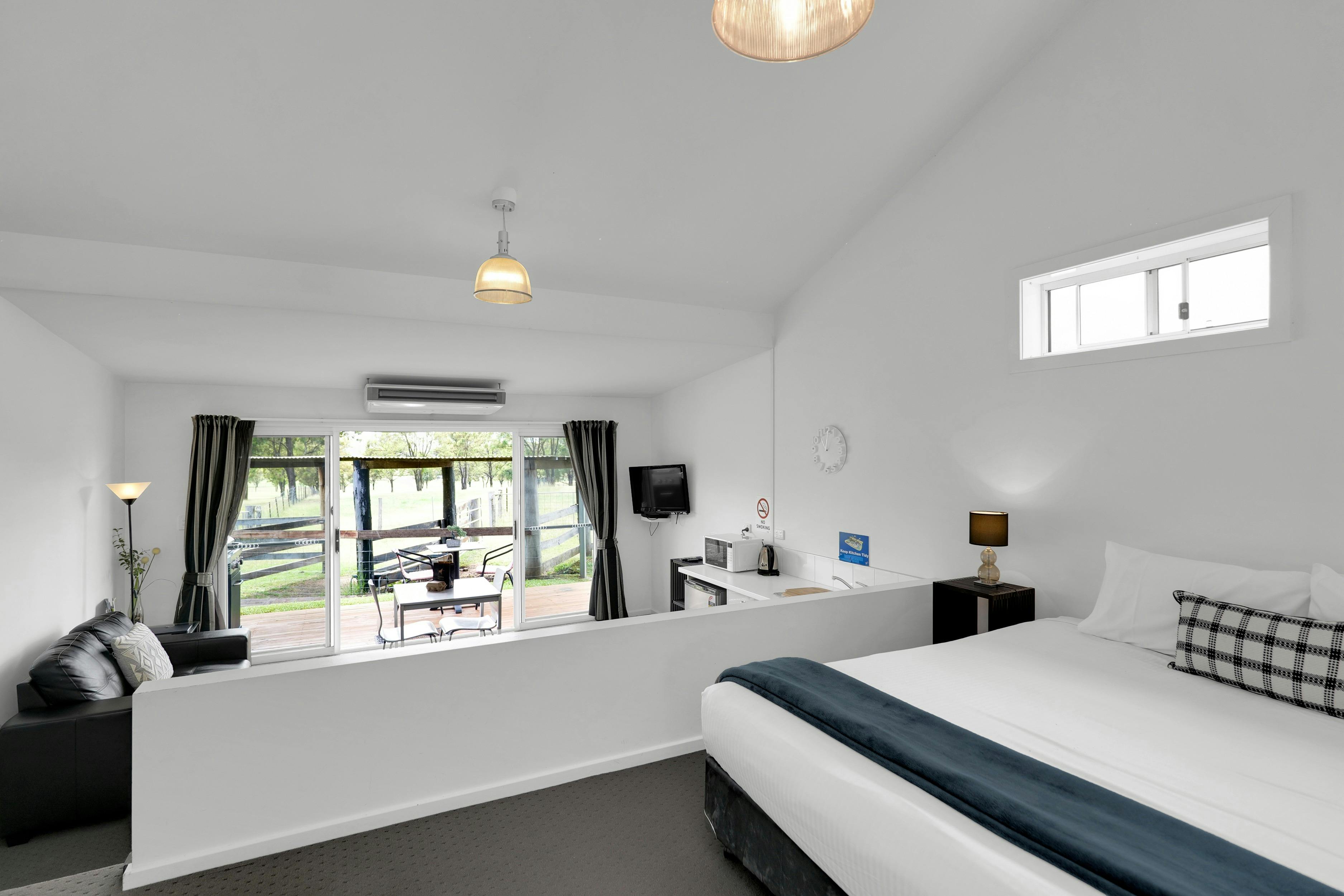 Stockyard Suite interior showing bedroom & sunken living room that opens onto veranda