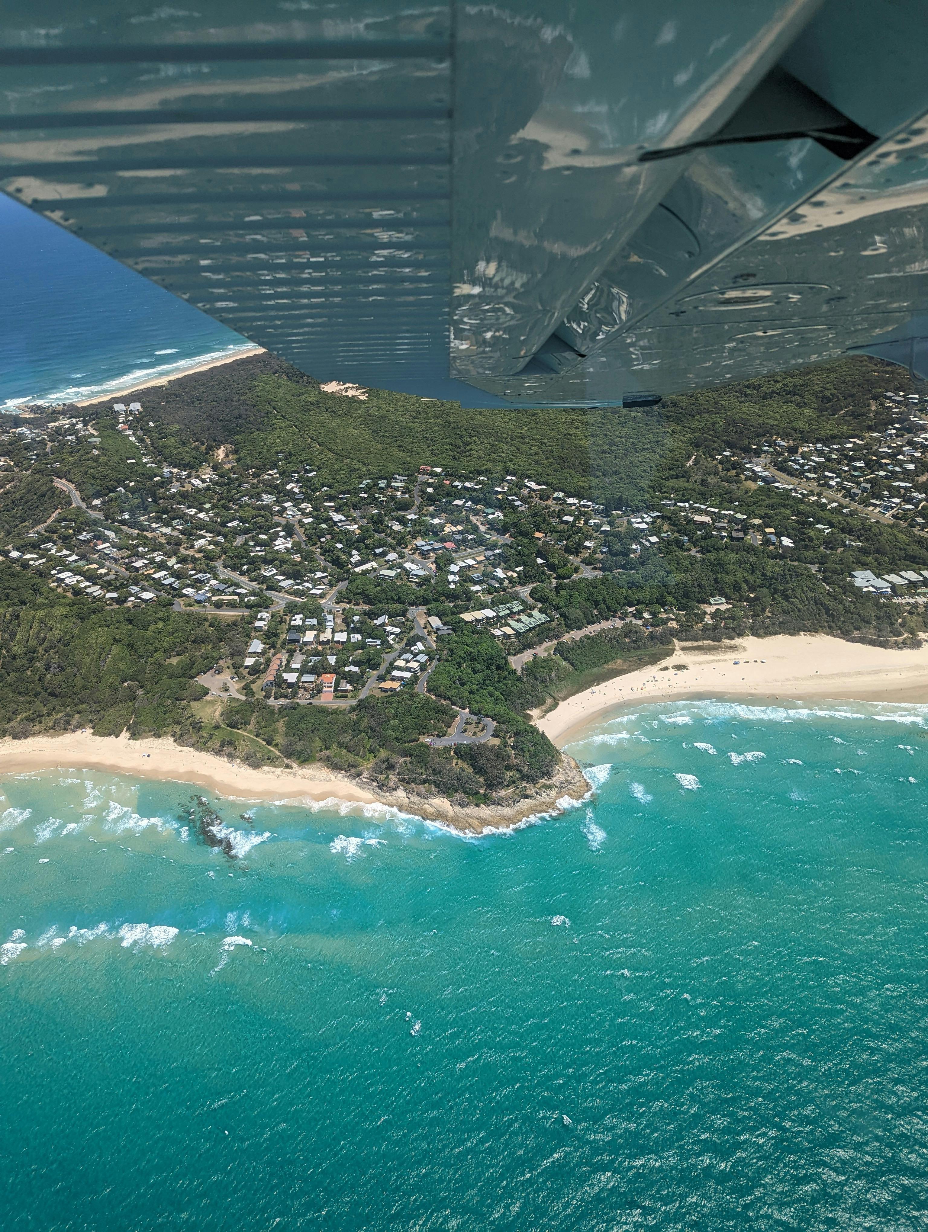 Looking down toward Point Lookout, North Stradbroke Island, from an aircraft window
