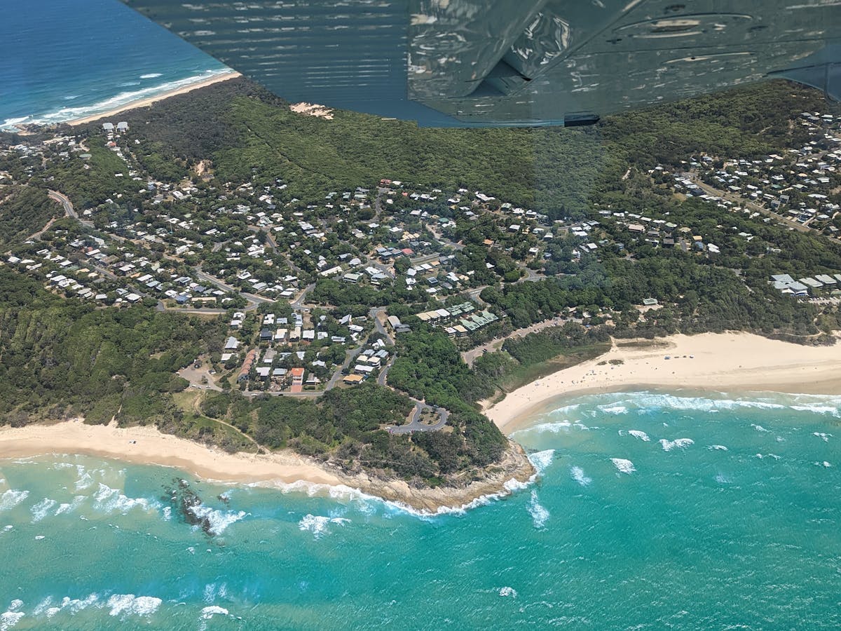 Looking down toward Point Lookout, North Stradbroke Island, from an aircraft window