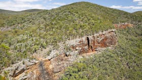 View of gorge and red, treeless cliff faces.