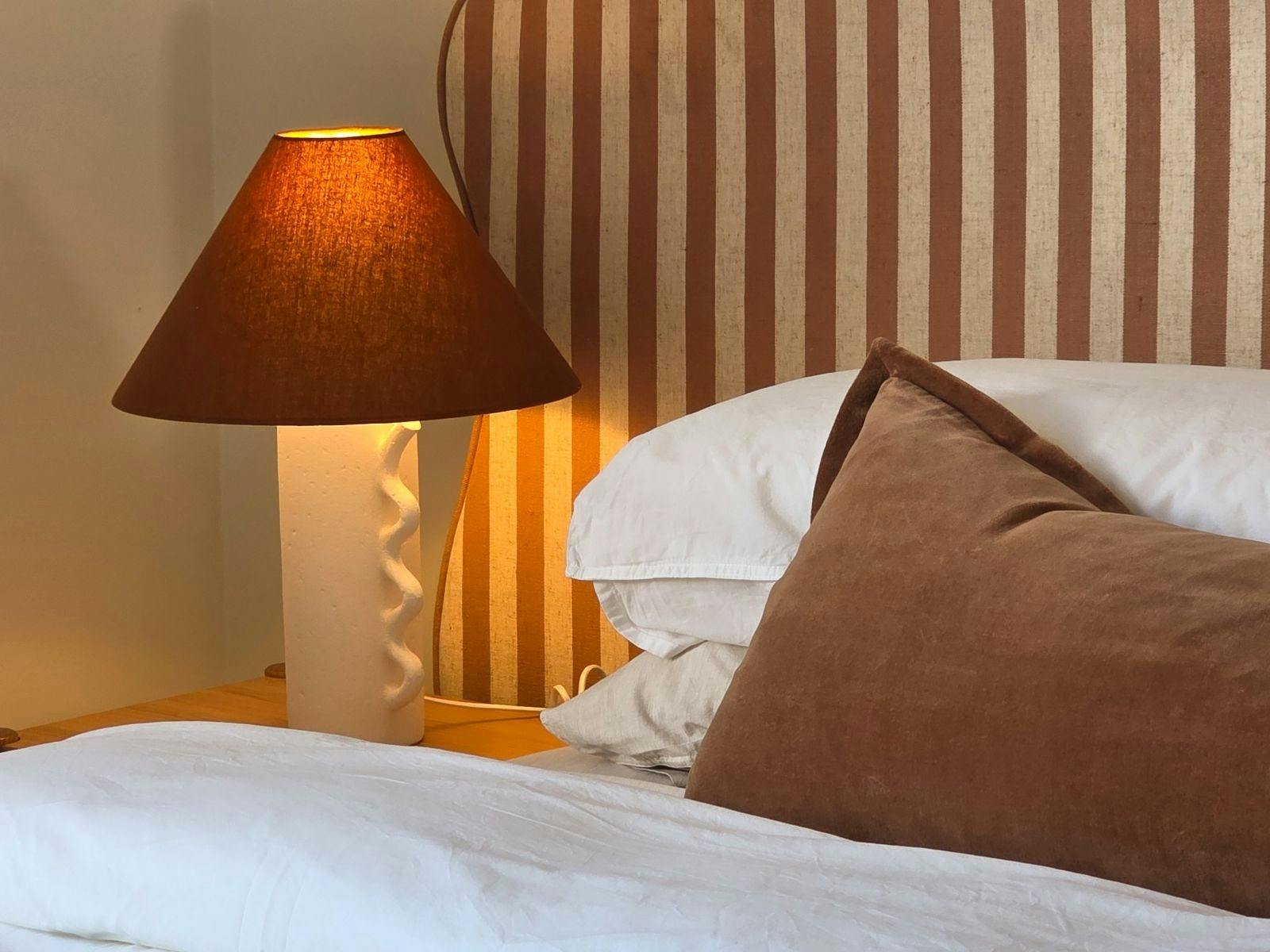 Light-filled bedroom with king bed, luxurious linen and ensuite bathroom