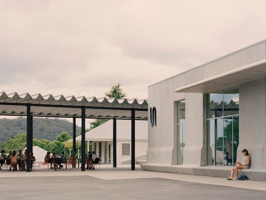 A photo of the concrete facade of the Art Museum with a bustling Ramox cafe adjacent