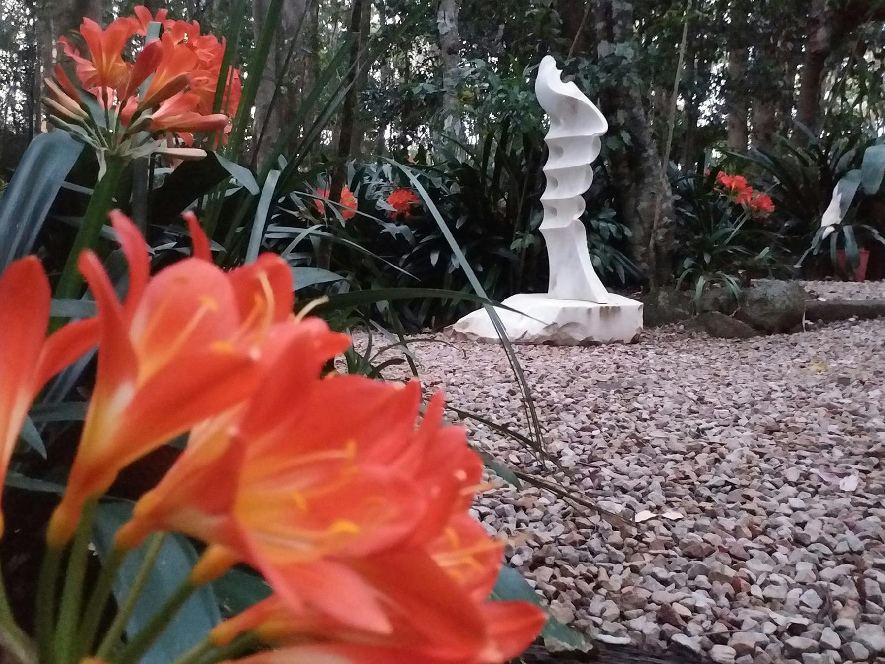 large white marble sculpture set in a rainforest