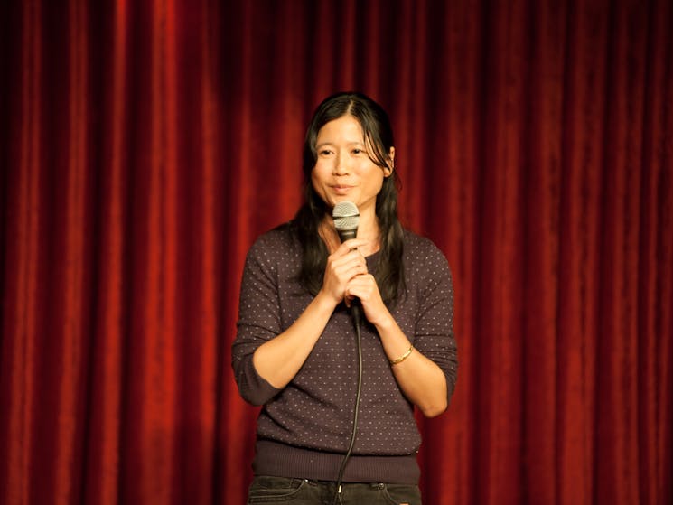 Thao telling jokes to audience in Sydney