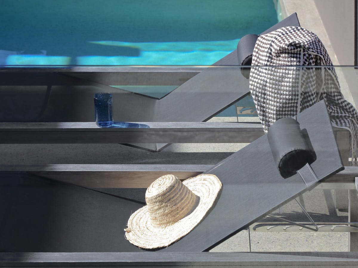 Poolside Escape: Lounge by the outdoor pool, embraced by sun-loungers, soaking in the sun's warmth