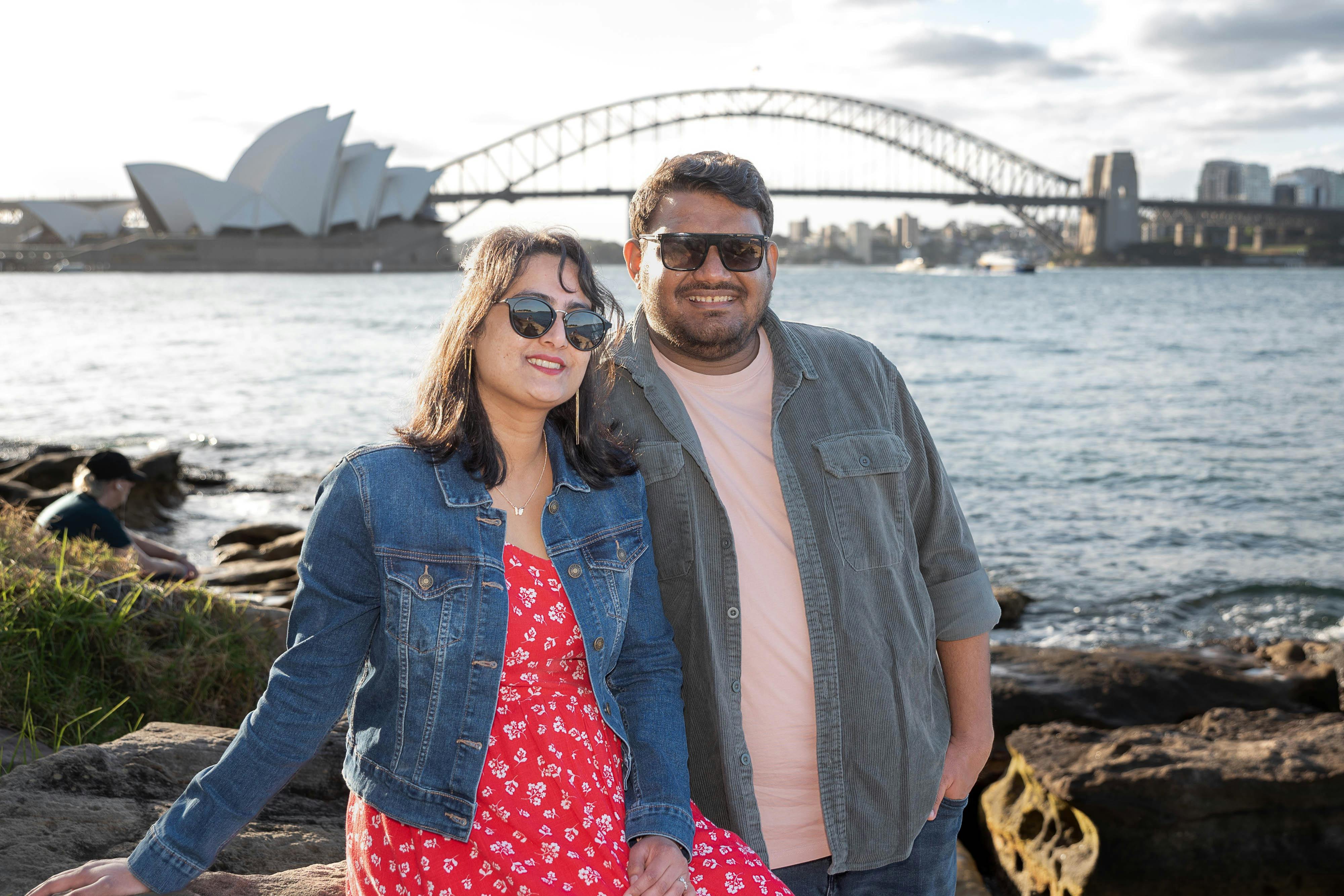 Happy couple smile with Opera House and Sydney Harbour Bridge background