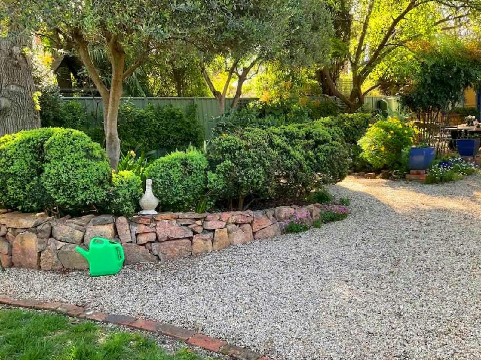 gravel pathway with stone wall
