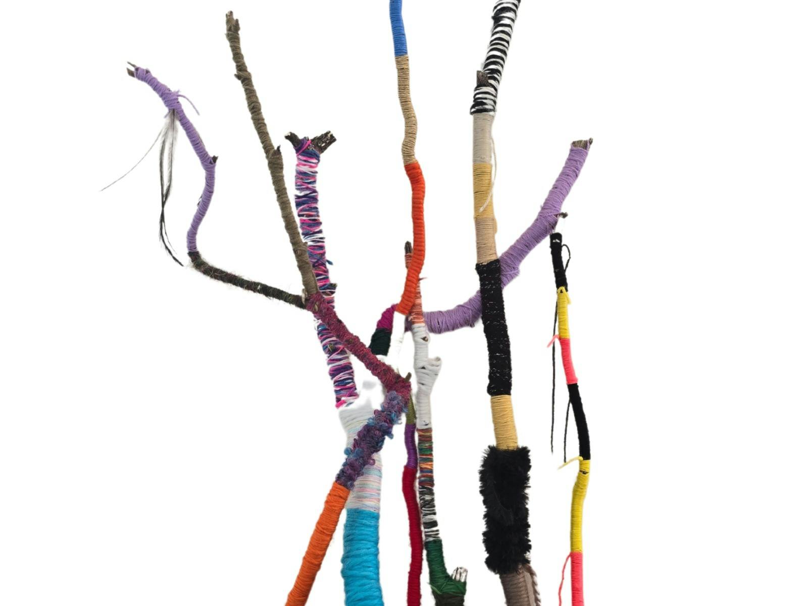 Branches of varying size have been wound in yarn in different colours and textures.