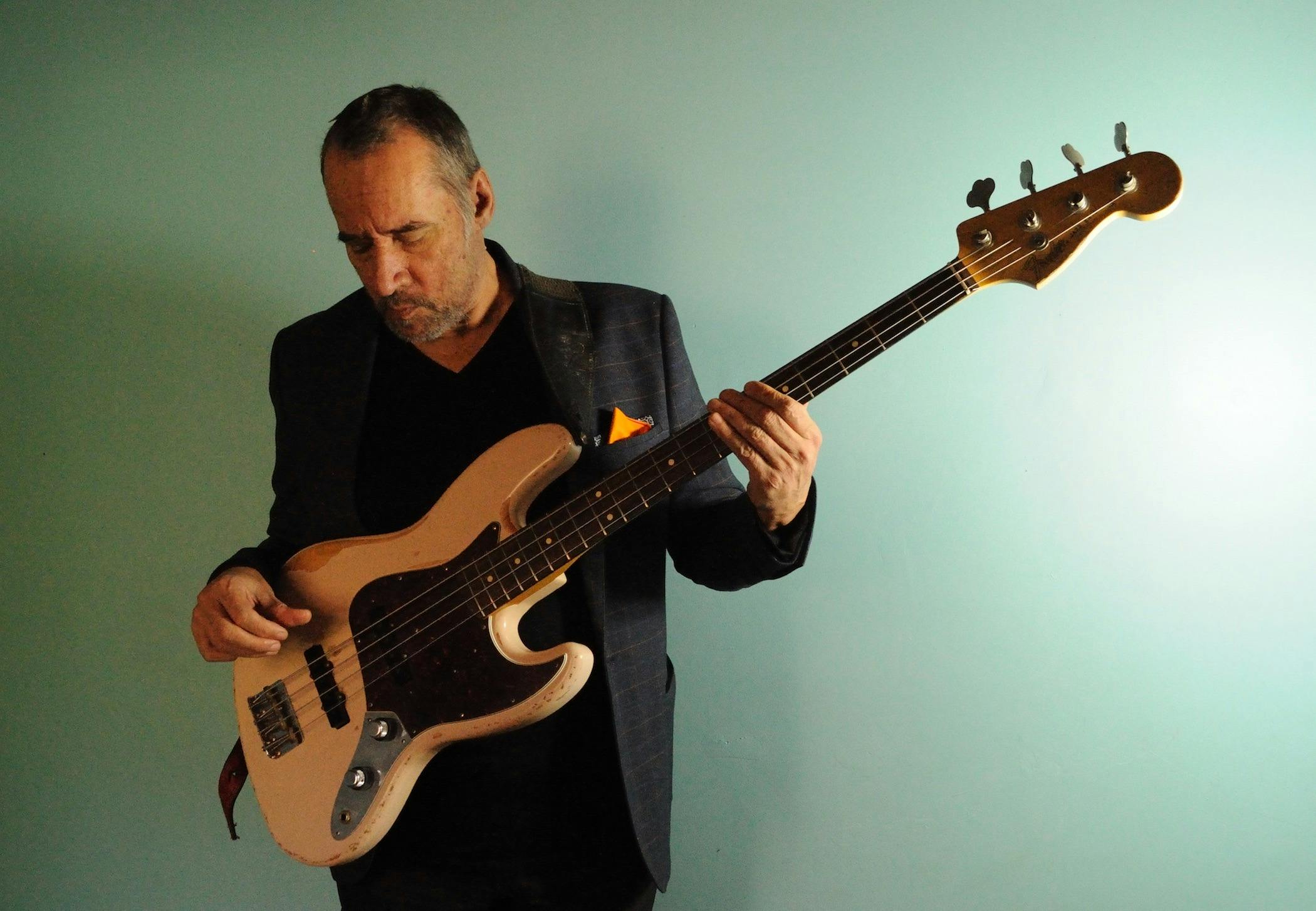 A man playing a bass guitar