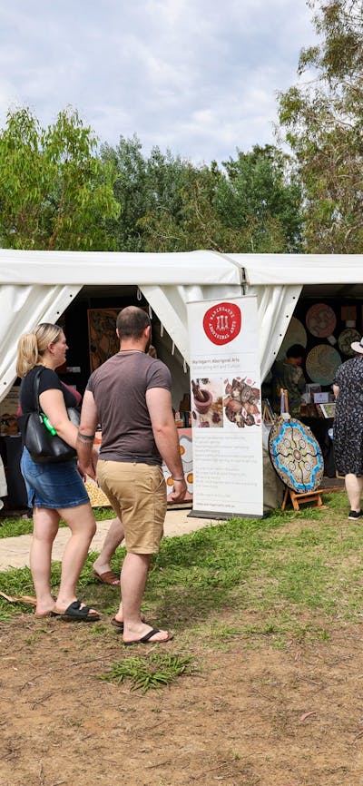 Buyers walking through the AIATSIS Indigenous Art Market