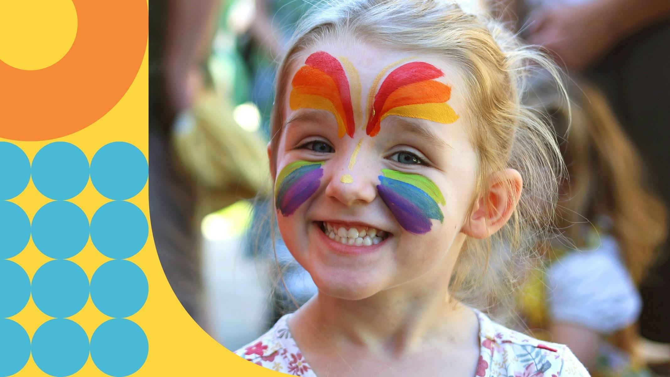 girl with face painted smiling at Family Fun Day at the Mint
