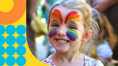 girl with face painted smiling at Family Fun Day at the Mint