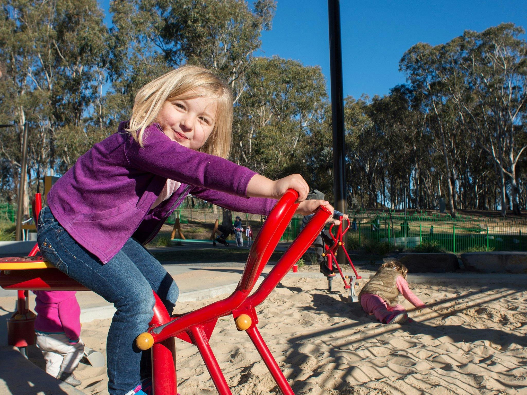 Girls playing in the sand at the Boundless Playground