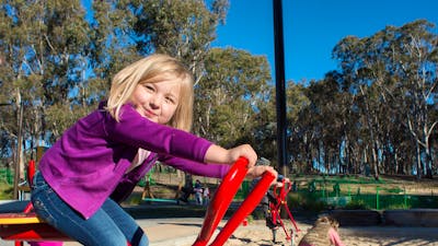 Girls playing in the sand at the Boundless Playground