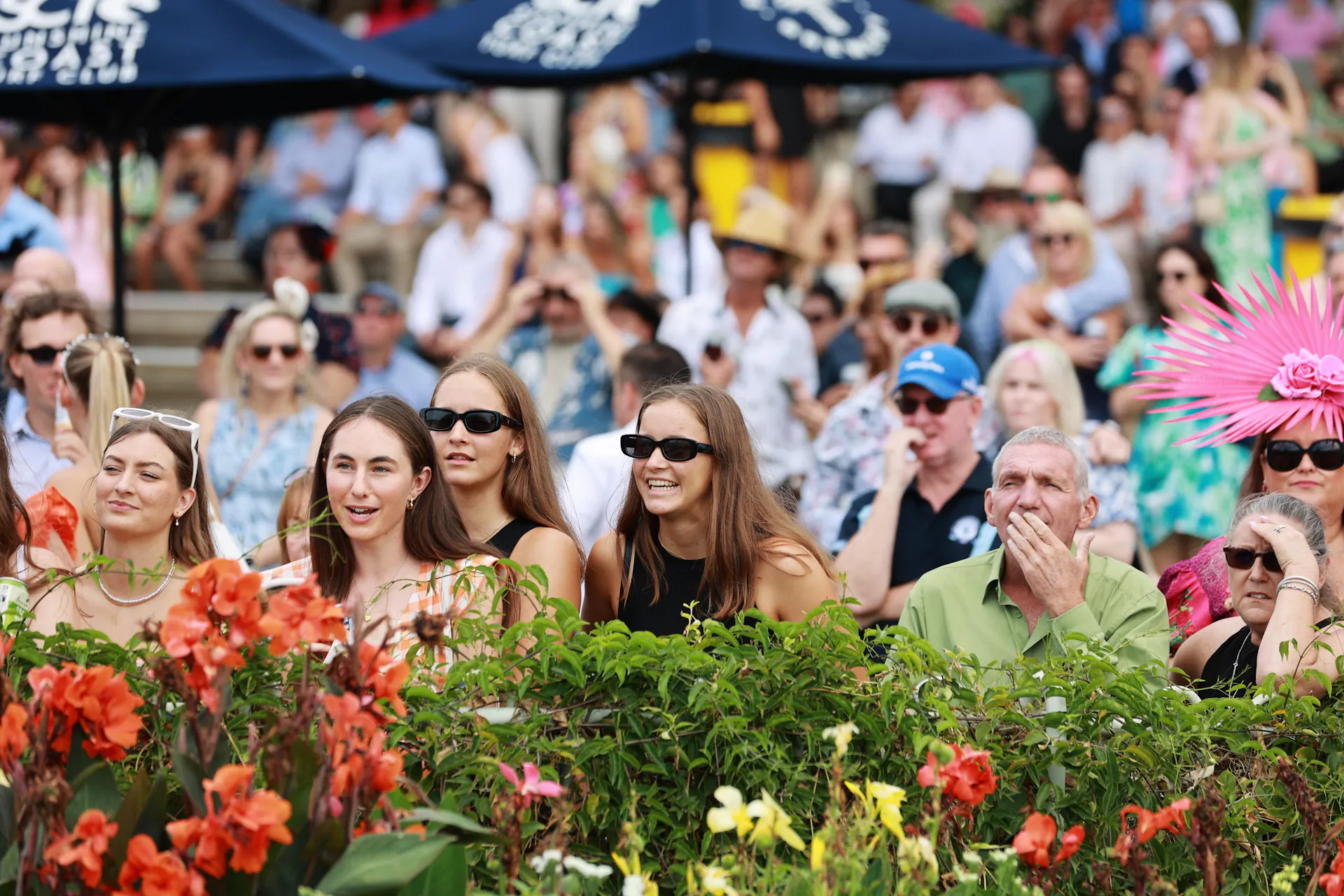 Excited people on the fenceline watching the races