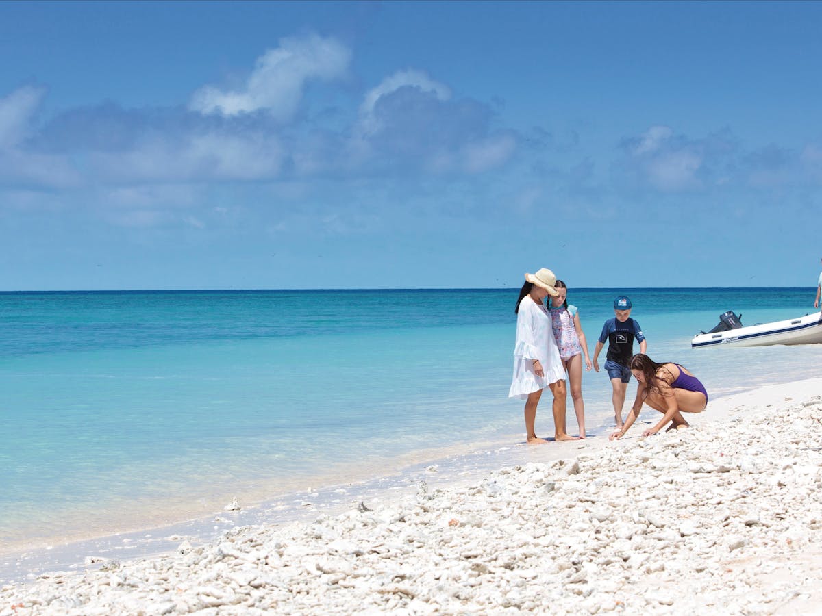 People on beach of cay. People on beach of cay.