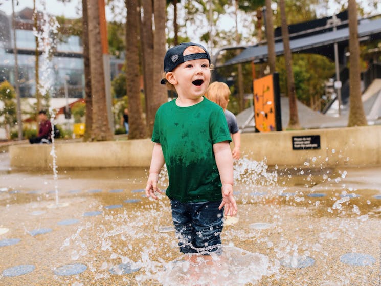 Young boy having a fun day out at The Playground, Darling Quarter