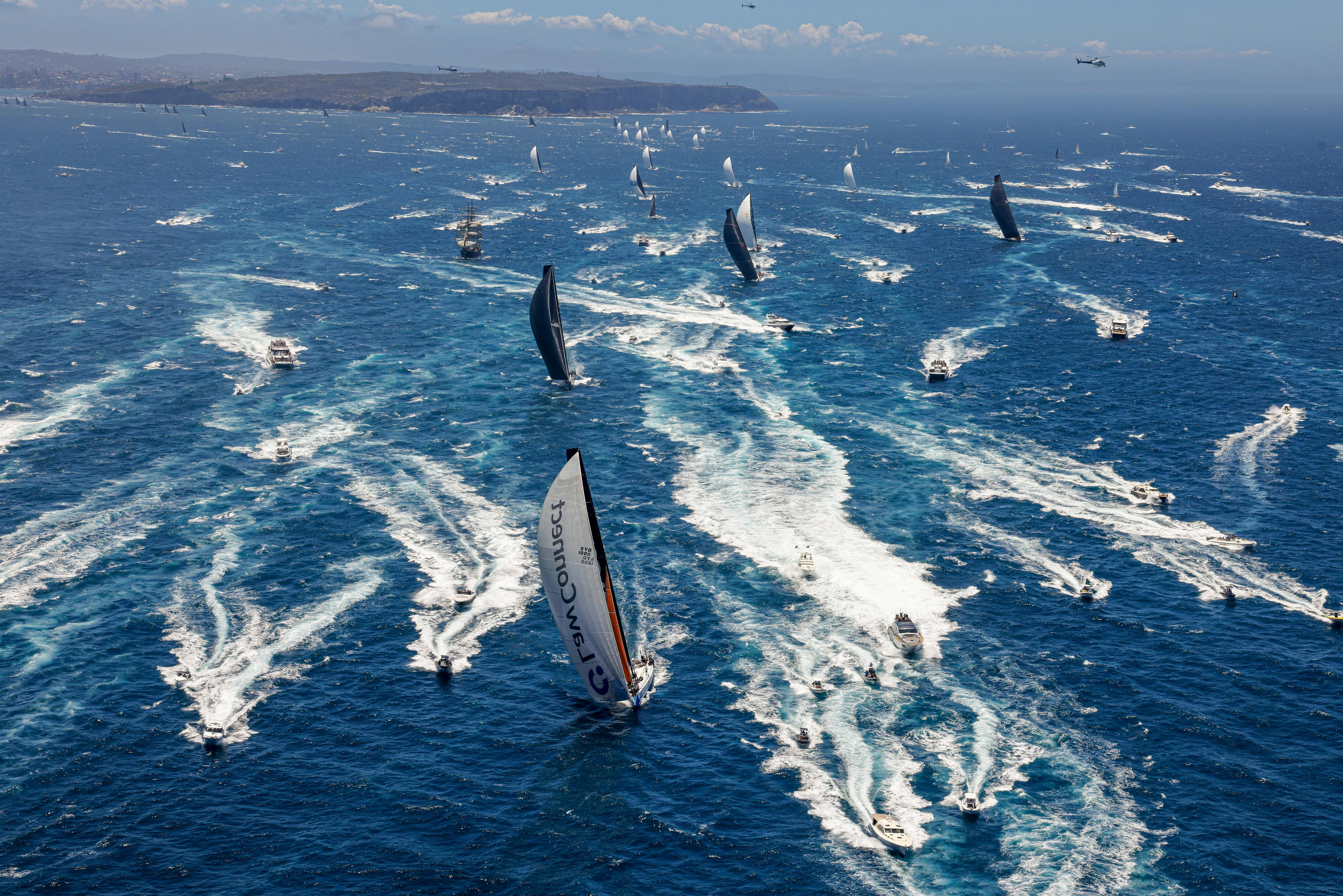 Ocean racing yachts cross the starting line in Sydney Harbour on their way to Tasmania