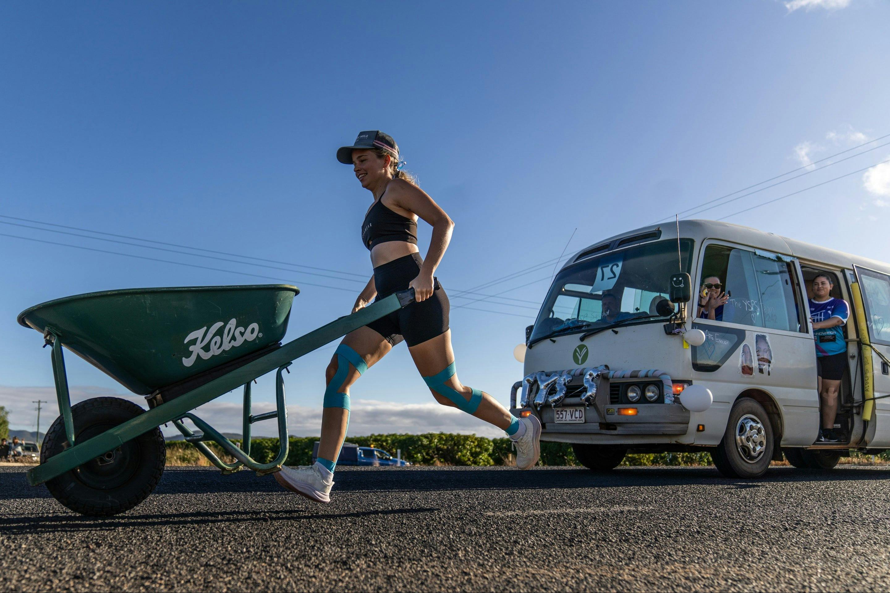 A woman runs with a wheelbarrow along the Wheelbarrow Way in Mareeba, Far North Queensland.