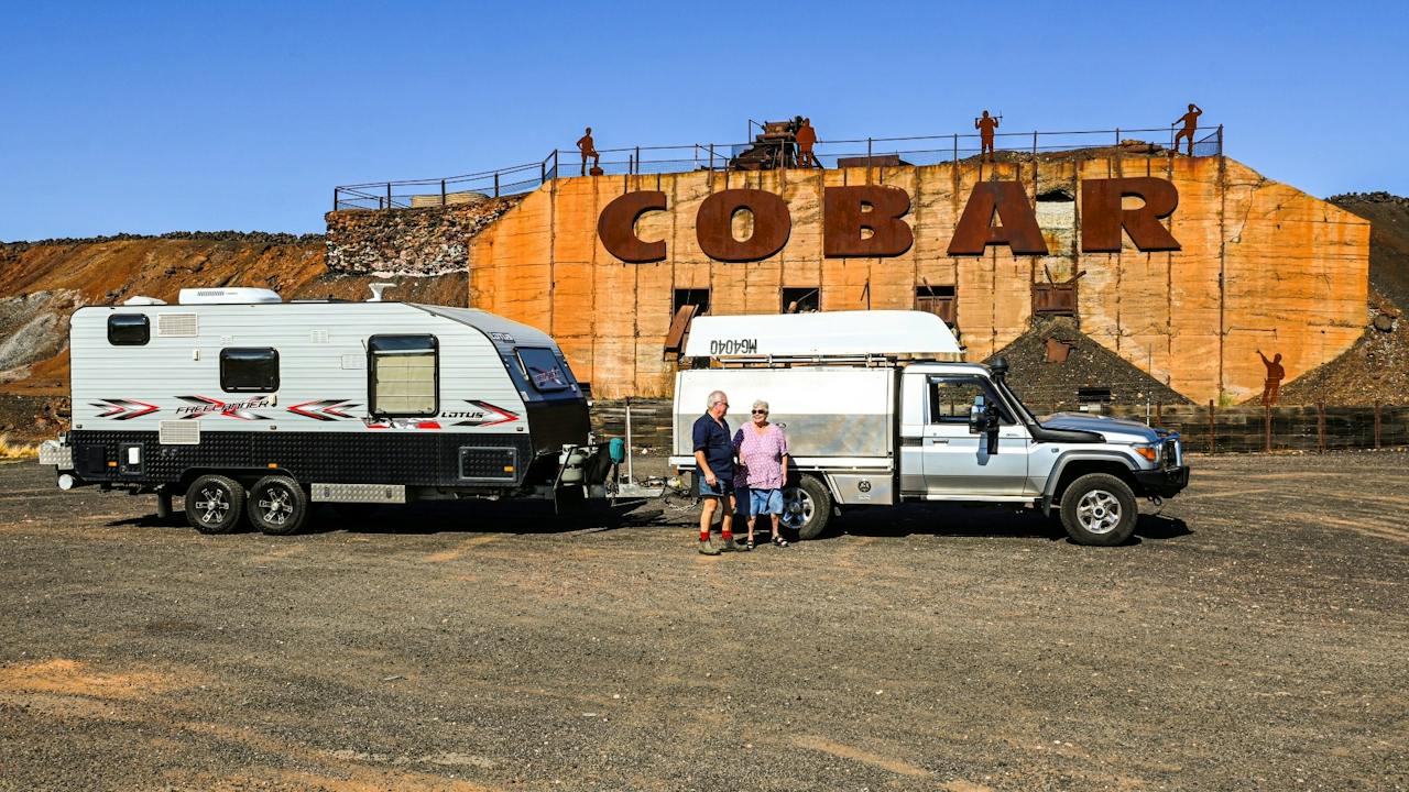 Travellers in front of the Cobar Sign