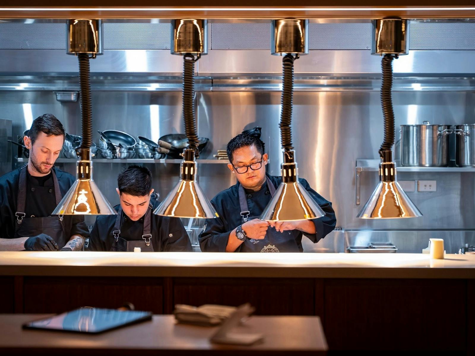 Chefs plating up in kitchen