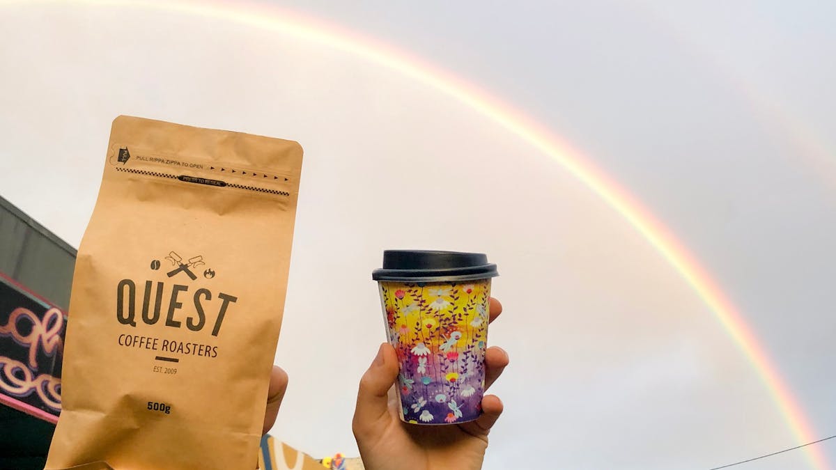 Organic roasted coffee beans and barista made artisan coffee available. Photographed under a rainbow