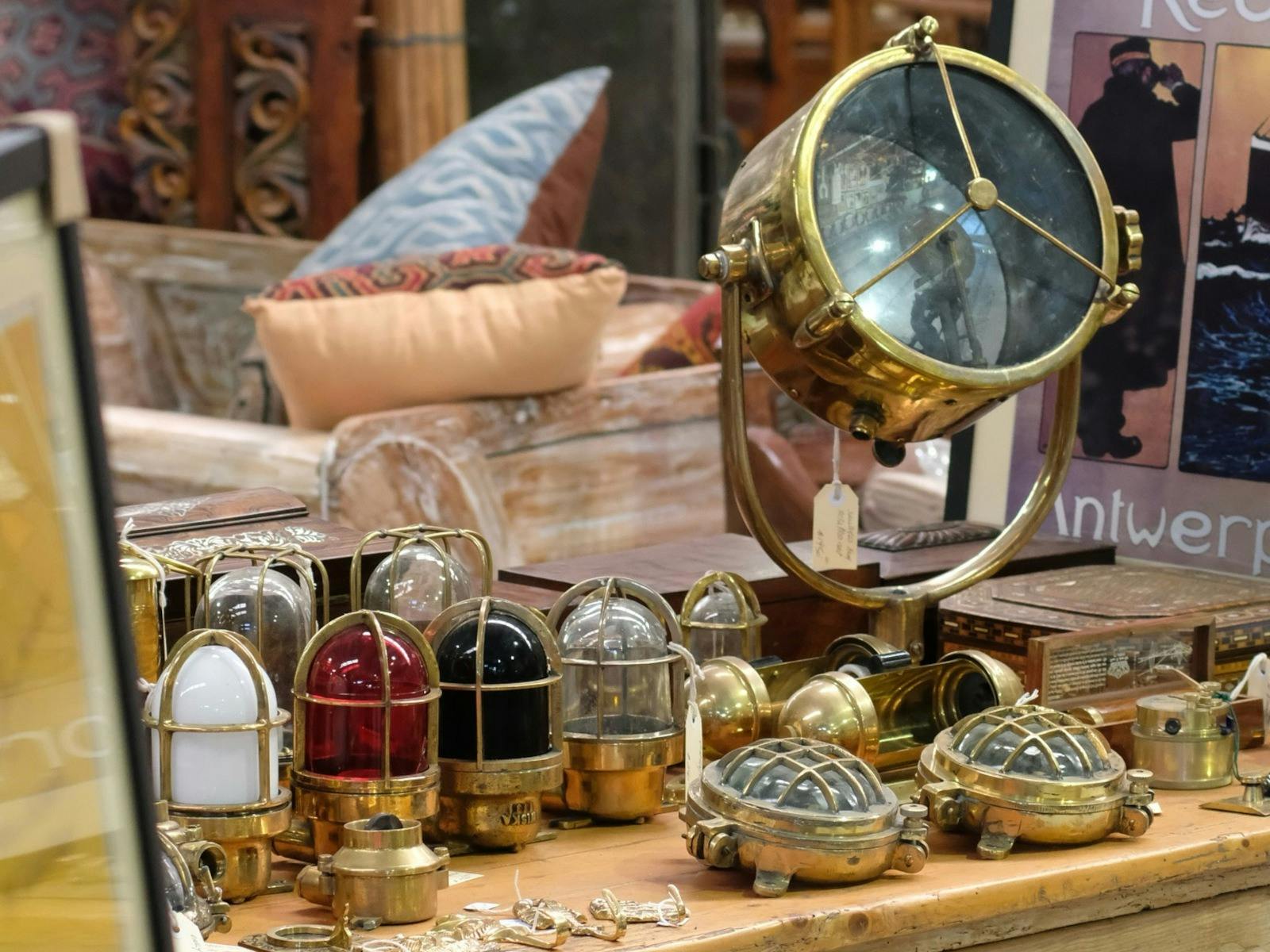 ship lights on a timber table with other antiques in background