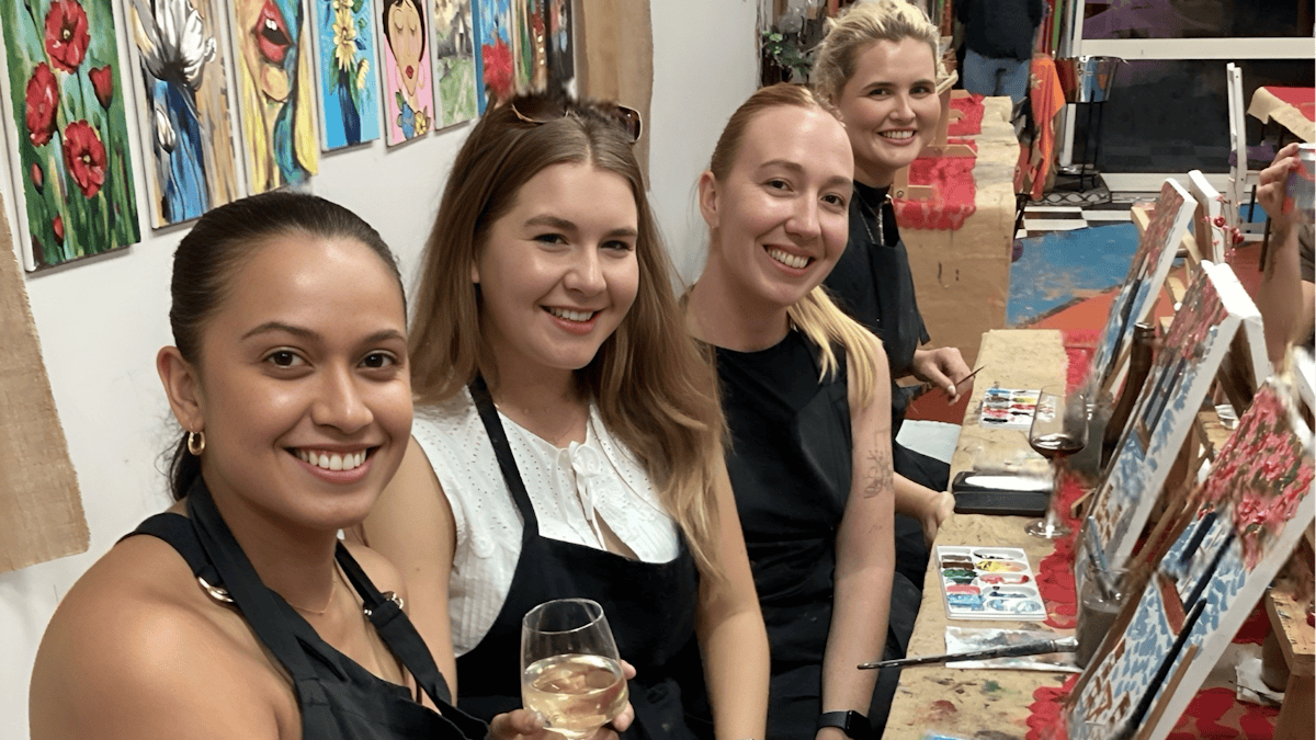 LAdies enjoy a wine while they are painting their masterpeices..