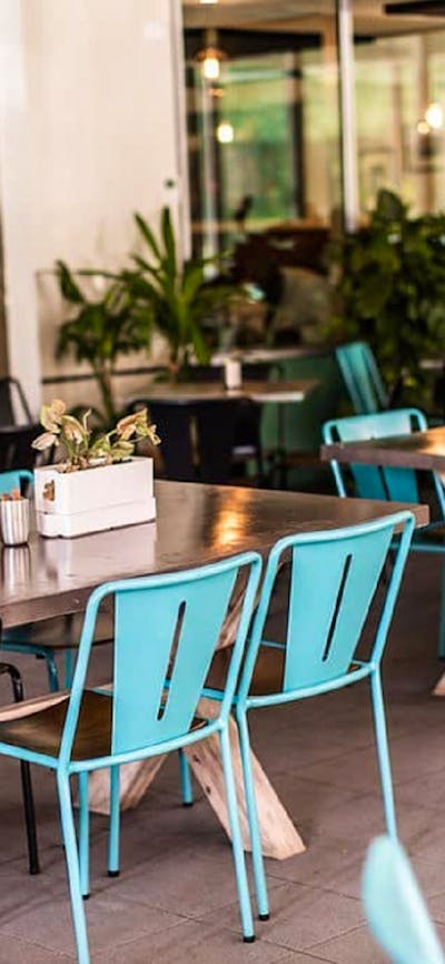 Empty outdoor tables with blue and black seating