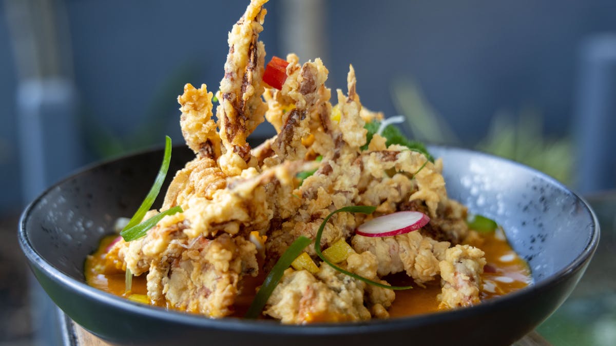 Battered, deep fried soft shell crab, served in a yellow curry sauce.