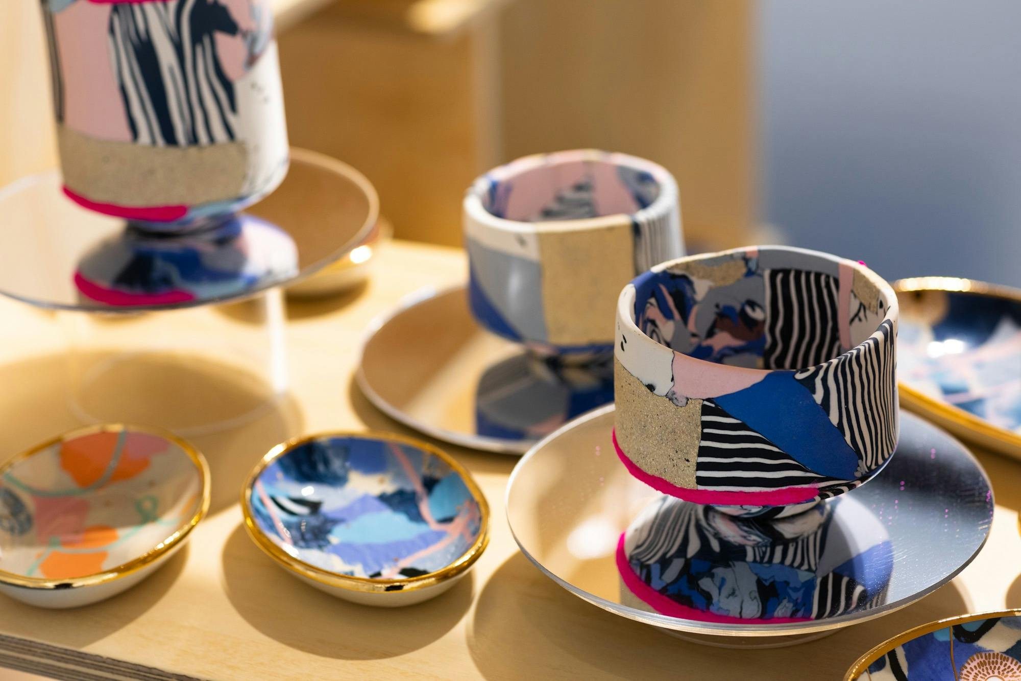 Colourful ceramic plates and bowls with gold.
