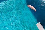 A diver plunges towards the water