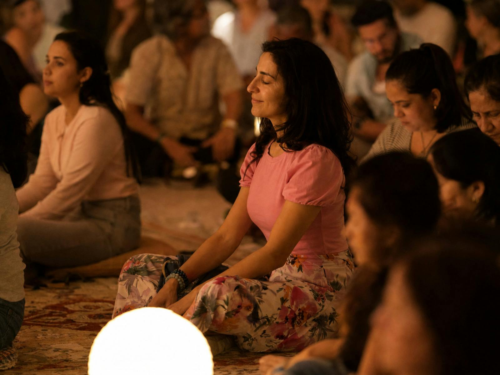 Woman seated in a crowd meditating