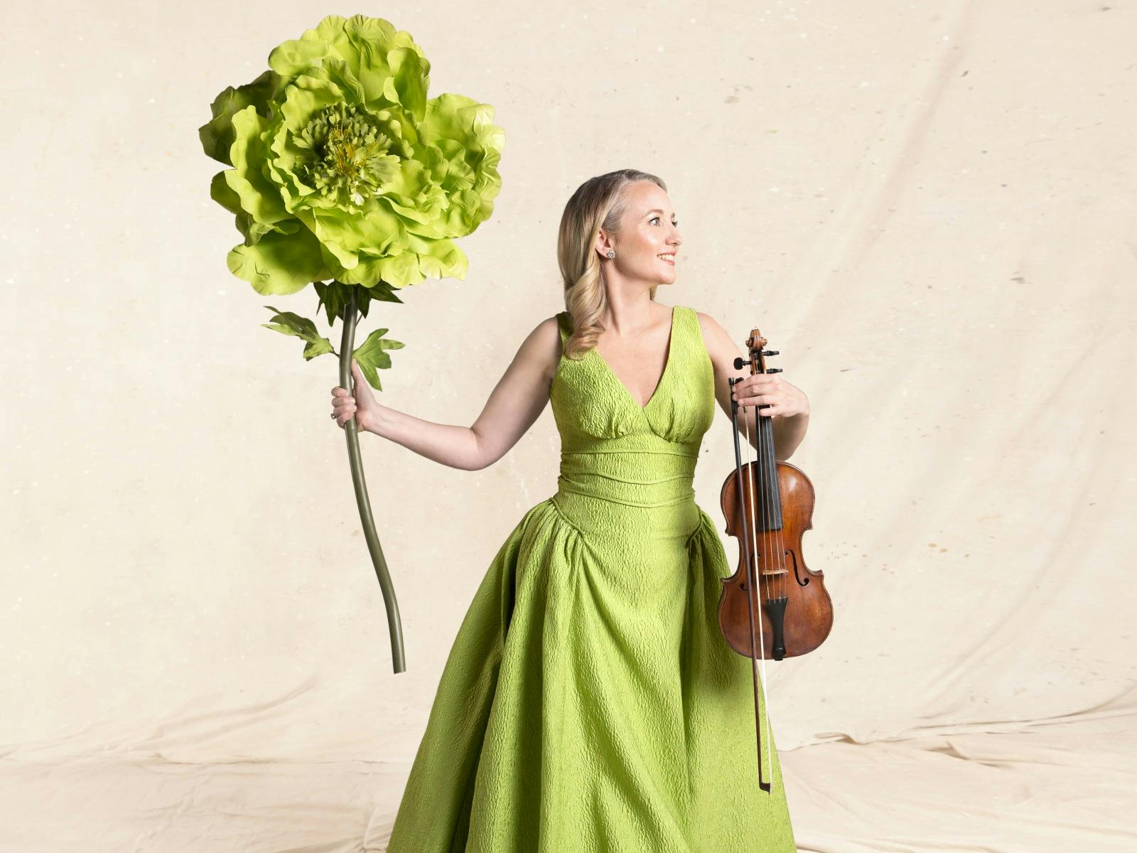 Skye McIntosh - A blonde woman in a lime green dress holding a violin and a lime glower