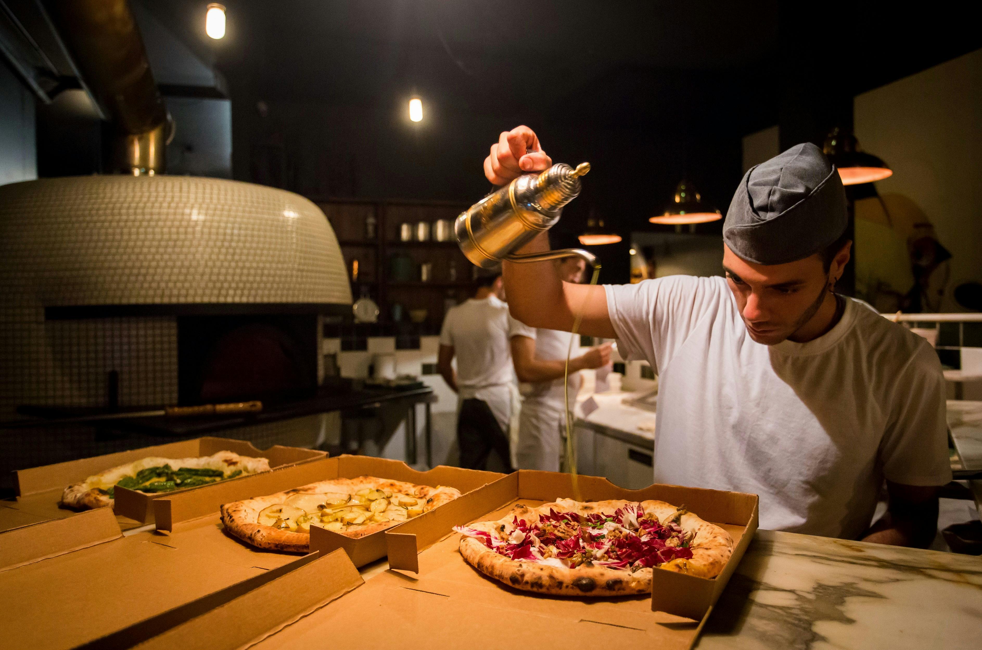 Chef preparing pizza's at Gigi Pizzeria, Newtown