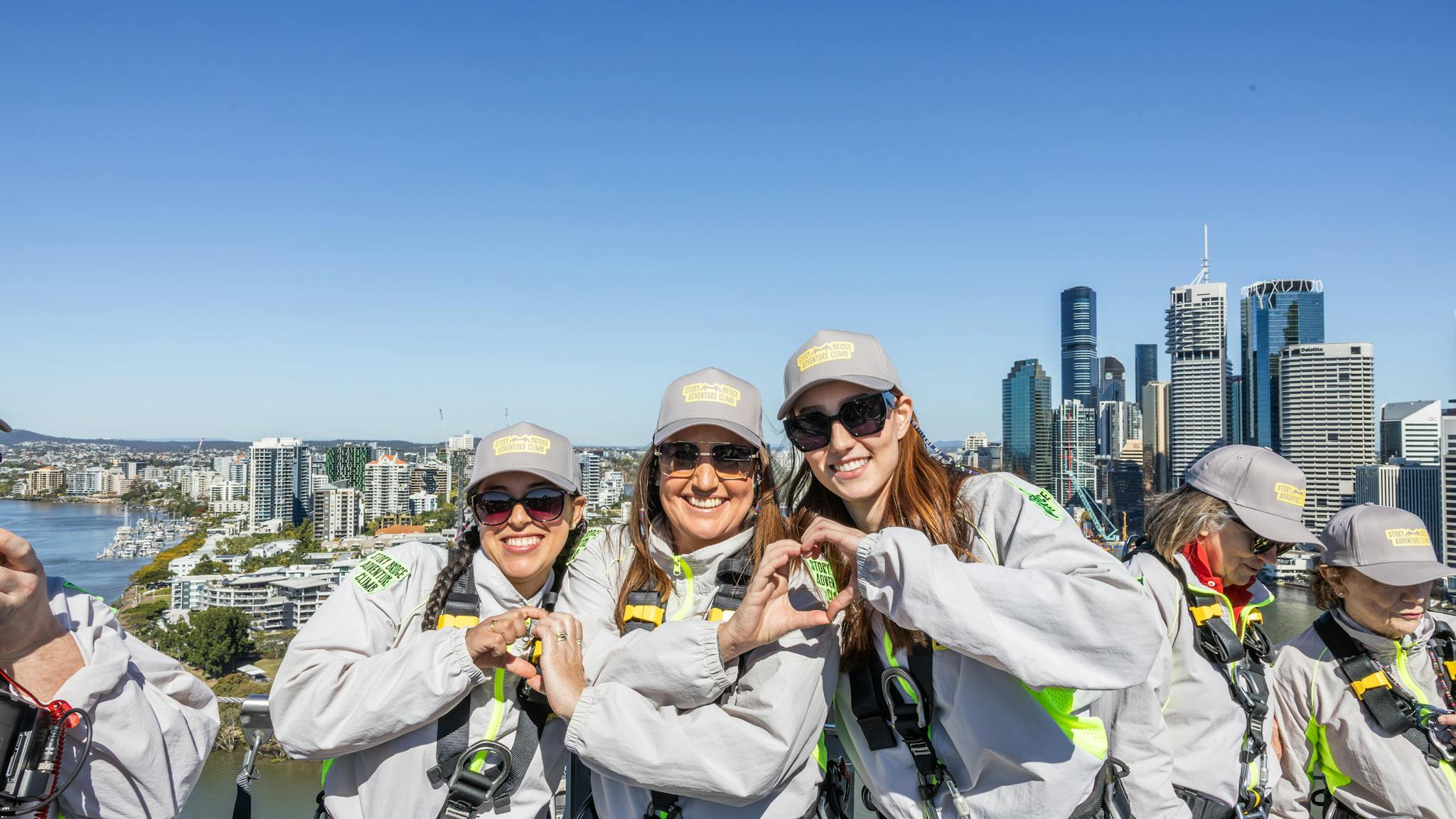 Climbers on the Brisbane Story Bridge Adventure Climb with city skyline views